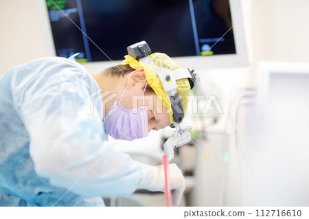 Surgeons are during maxillofacial operation using microscope and endoscope in modern hospital. Teamwork of doctors. Maxillofacial surgery. Surgeons are during maxillofacial operation using microscope and endoscope in modern hospital. Teamwork of doctors. Maxillofacial surgery. 112716610