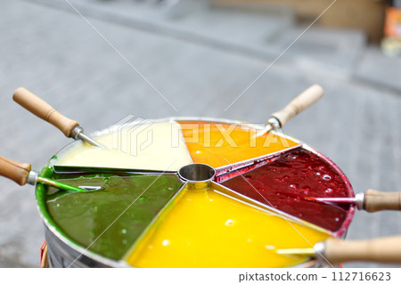 Tray with vibrant multicolored caramel for lollipops on stick in Istanbul, Turkey. Authentic Ottoman mastic, macun sekeri. Turkish traditional dessert toffee paste candy. Street food Tray with vibrant multicolored caramel for lollipops on stick in Istanbul, Turkey. Authentic Ottoman mastic, macun sekeri. Turkish traditional dessert toffee paste candy. Street food 112716623