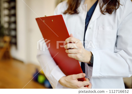 Rehab doctor is on appointment of patient in gym. PMR specialized in physically-based rehabilitation and recovery. This treat using exercises and orthopedics. 112716652