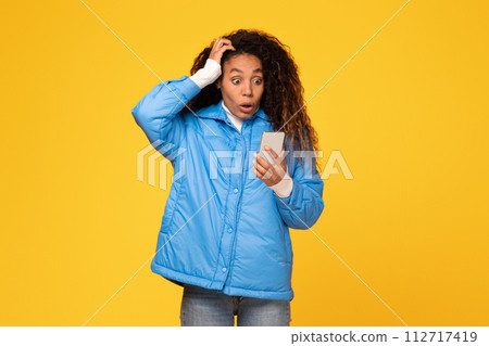 Shocked lady reads bad message on phone, touches head Shocked lady reads bad message on phone, touches head 112717419