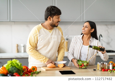 Happy young indian vegetarian couple cooking together at home 112717482