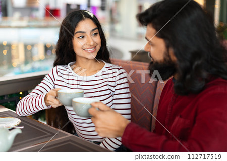 Beautiful indian couple have romantic date at coffee shop Beautiful indian couple have romantic date at coffee shop 112717519