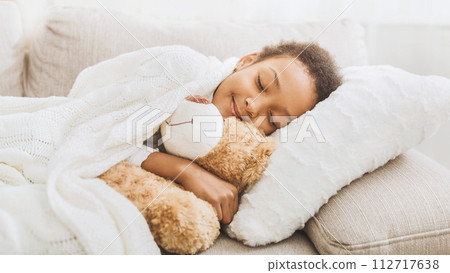 Adorable little girl sleeping in bed with her toy Adorable little girl sleeping in bed with her toy 112717638