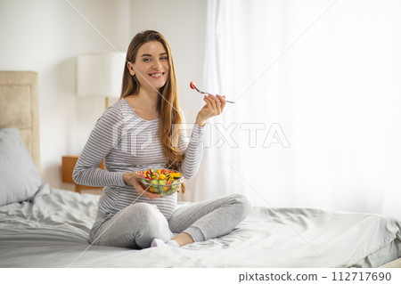 Pregnancy Nutrition. Pregnant Woman Eating Salad While Sitting On Bed At Home 112717690