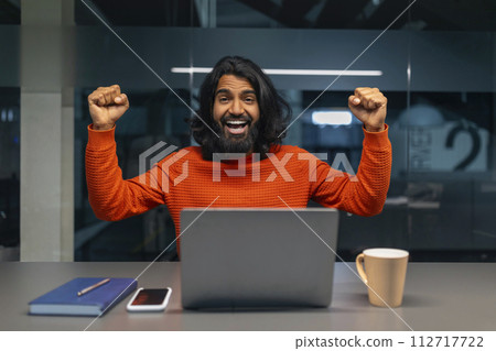 Man excited with computer in office 112717722