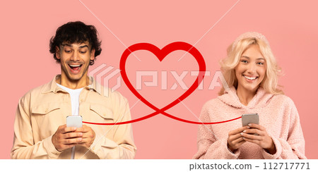 An overjoyed man in a light jacket laughs at his phone, and a delighted woman in a fuzzy pink sweater looks at hers An overjoyed man in a light jacket laughs at his phone, and a delighted woman in a fuzzy pink sweater looks at hers 112717771