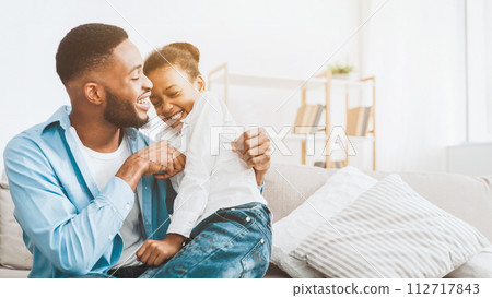 Father and daughter playing together at home Father and daughter playing together at home 112717843