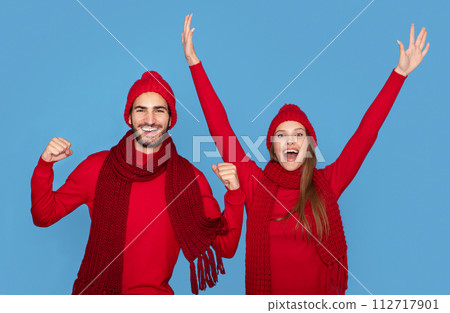 Holiday Spirit. Portrait Of Overjoyed Young Couple Wearing Winter Hats Celebrating Success 112717901