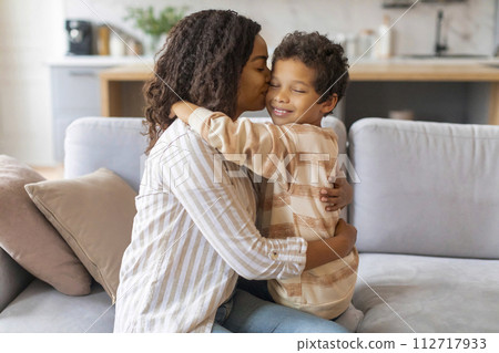 Black Mom Kissing Her Preteen Son While Sitting Together On Couch Black Mom Kissing Her Preteen Son While Sitting Together On Couch 112717933