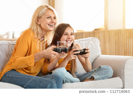Happy teen girl having fun with her grandmother at home Happy teen girl having fun with her grandmother at home 112718063