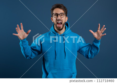 Portrait Of Angry Young Man Screaming At Camera With Rage 112718460