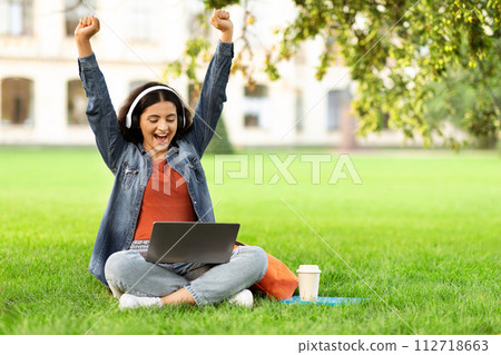 Excited eastern woman student celebrating success, passed exam 112718663