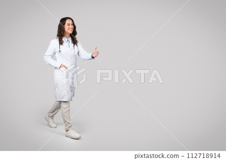Positive european woman doctor in uniform give hand to patient to handshake on light background, free space Positive european woman doctor in uniform give hand to patient to handshake on light background, free space 112718914