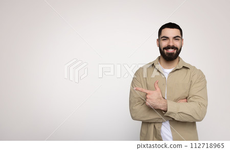 Happy and confident bearded man giving a thumbs-up gesture, casually 112718965