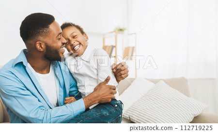 Afro Father Tickling Daughter, Having Fun And Playing At Home Afro Father Tickling Daughter, Having Fun And Playing At Home 112719225