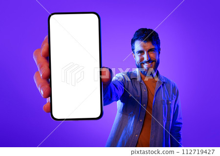 Cheerful Guy Holds Large Smartphone Showing Empty Device Screen, Collage Cheerful Guy Holds Large Smartphone Showing Empty Device Screen, Collage 112719427