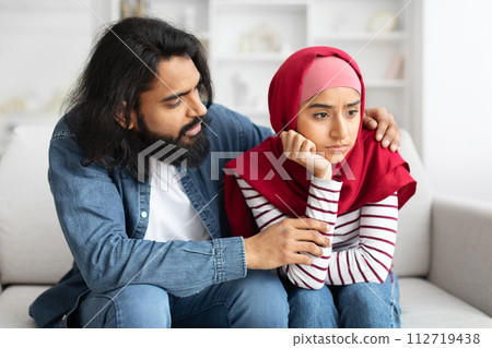 Caring Arab Man Comforting His Upset Muslim Wife At Home, Caring Arab Man Comforting His Upset Muslim Wife At Home, 112719438