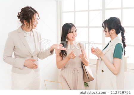 女性朋友、同事和銷售人員在珠寶店(百貨公司、百貨公司、品牌商品)選擇戒指 女性朋友、同事和銷售人員在珠寶店(百貨公司、百貨公司、品牌商品)選擇戒指 112719791