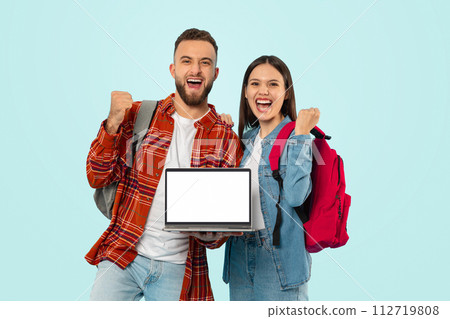 Joyful Couple Showing Laptop Mockup Screen And Gesturing Yes, Studio Joyful Couple Showing Laptop Mockup Screen And Gesturing Yes, Studio 112719808