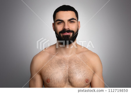 Studio shot of handsome bearded arab man posing shirtless 112719850
