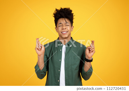 Excited young african american man make a wish Excited young african american man make a wish 112720431