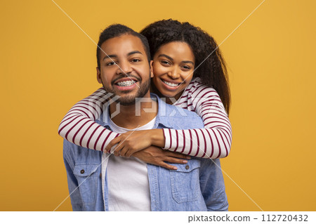 Portrait Of Happy Loving African American Couple Posing Together Over Yellow Background 112720432