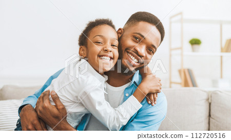 Fatherhood concept. Lovely father and daughter embracing Fatherhood concept. Lovely father and daughter embracing 112720516