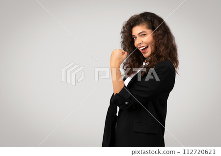 Joyful businesswoman with victorious fist pump, copy space Joyful businesswoman with victorious fist pump, copy space 112720621