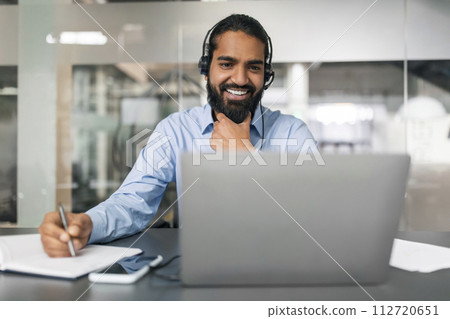 Smiling bearded young guy employee have online conference 112720651