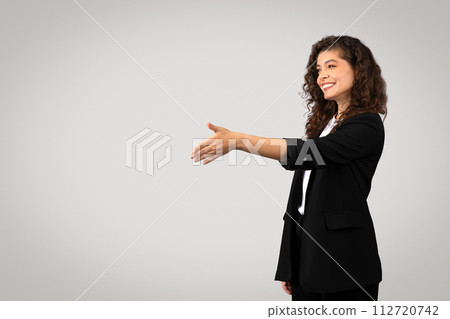 Businesswoman reaching out for handshake, free space Businesswoman reaching out for handshake, free space 112720742