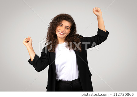 Exuberant young businesswoman celebrating success 112720866