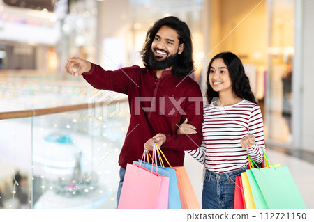 Happy Indian Couple Doing Shopping In Mall Together Happy Indian Couple Doing Shopping In Mall Together 112721150