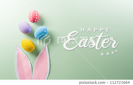 Easter party concept. Top view of easter bunny ears and colorful eggs on pastel background with copyspace for the text. 112721664