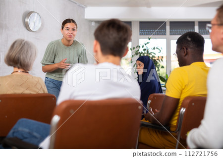 Young positive woman giving lecture in office 112721756