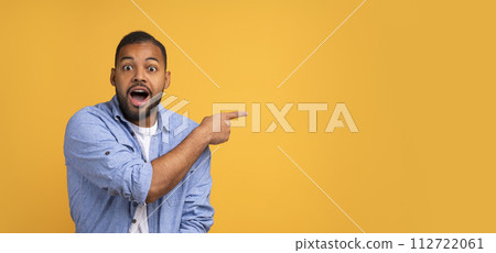 Shocking Offer. Emotional Black Man Pointing At Copy Space With Hand 112722061