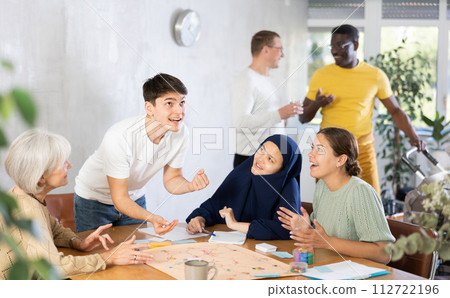 Group of of different years people playing tabletop game Group of of different years people playing tabletop game 112722196