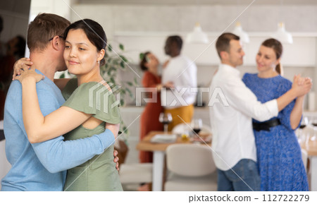 Asian woman enjoying slow dance with husband at home gathering 112722279