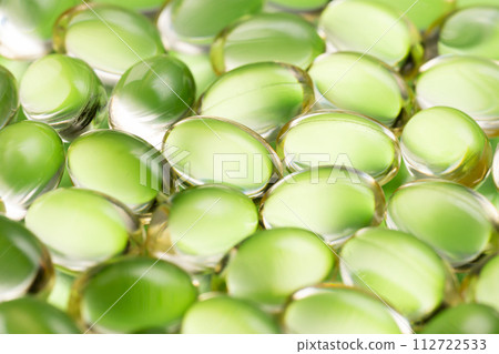 Green pill medicine supplement green background 112722533