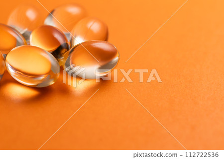 Orange pill medicine supplement orange background 112722536