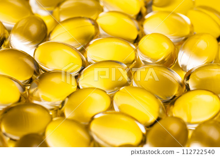 Yellow pill medicine supplement yellow background 112722540