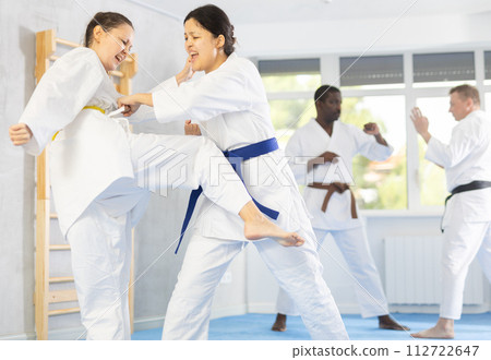 Multinational pupils train to perform defensive karate installations and attacking combat techniques 112722647