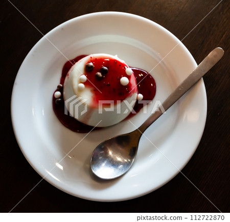 Creamy mousse with berry and chocolate topping at plate Creamy mousse with berry and chocolate topping at plate 112722870