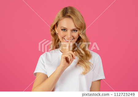 Portrait Of Pretty Blonde Young Lady Showing Hush Sign, Studio 112723249
