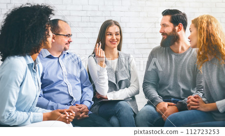 Smiling Psychologist Talking To Group Members At Therapy Session In Rehab 112723253