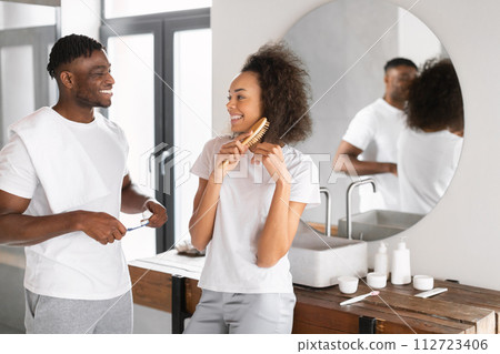 black couple leisurely getting ready together spending time in bathroom black couple leisurely getting ready together spending time in bathroom 112723406