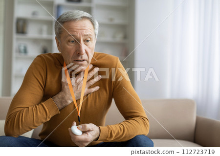 Sick senior man touching chest, pressing alarm button for emergency Sick senior man touching chest, pressing alarm button for emergency 112723719
