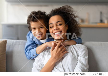 Cheerful mother and son sharing hug and smile Cheerful mother and son sharing hug and smile 112723839
