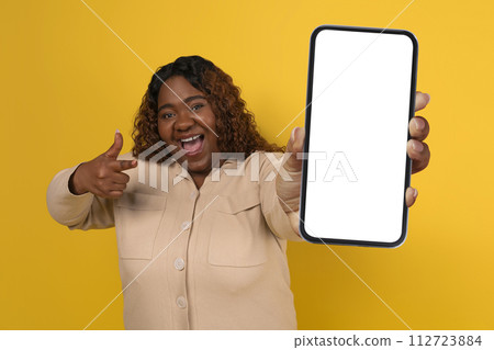 Chubby Black Woman Showing Big Smartphone With White Blank Screen 112723884