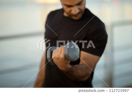 Cropped shot of fitness guy having workout session with dumbbells Cropped shot of fitness guy having workout session with dumbbells 112723997