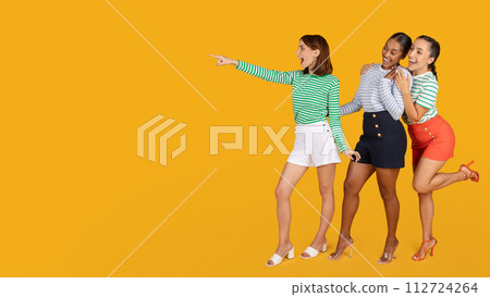 Excited young multiracial women girlfriends looking at copy space 112724264